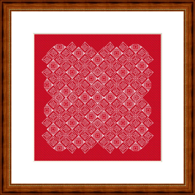 May include: A framed cross-stitch with a repeating white geometric pattern on a red background. The design features diamond and square shapes. The frame is dark brown. The artwork is in a wooden frame.