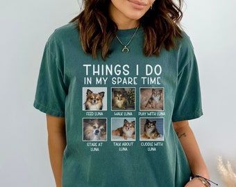 May include: A dark green short-sleeve t-shirt featuring the white text "THINGS I DO IN MY SPARE TIME" above six square photo panels of a long-haired chihuahua. Each panel includes a caption: "FEED LUNA," "WALK LUNA," "PLAY WITH LUNA," "STARE AT LUNA," "TALK ABOUT LUNA," and "CUDDLE WITH LUNA."
