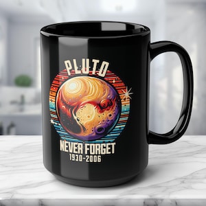 May include: Black ceramic mug with a retro-style design featuring a colorful illustration of Pluto with the text "Pluto Never Forget 1930-2006".