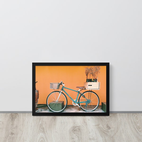 A bicycle with a crate of wine on its carrier against an orange wall