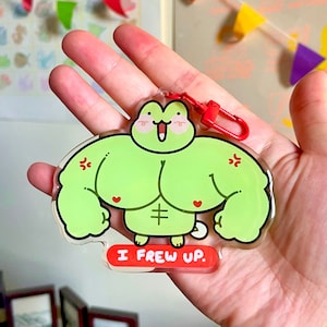 May include: Green frog character with red hearts and a six-pack, wearing a red keychain with the text "I Frew Up."