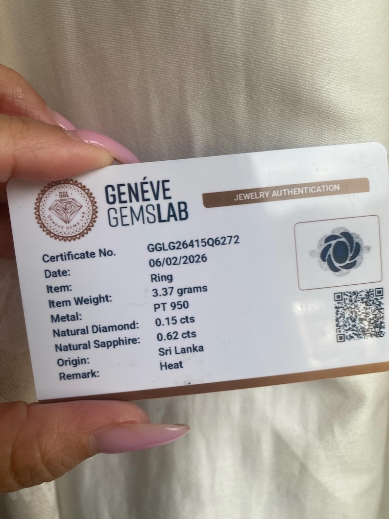 May include: A white Gen&eacute;ve Gemslab jewelry authentication card for a ring. The card lists certificate number GGLG26415Q6272, date 06/02/2026, weight 3.37 grams, PT 950 metal, 0.15 cts natural diamond, 0.62 cts natural sapphire, origin Sri Lanka, and heat.