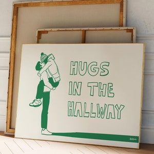 Könnte beinhalten: Ein weißer Leinwanddruck mit einer grünen Illustration von zwei Personen, die sich in einem Flur umarmen. Der Text "HUGS IN THE HALLWAY" ist in grün unter der Illustration geschrieben.