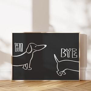 May include: Black and white illustration of two dachshunds on a black background with a gold frame. The dachshund on the left says "HI" and the dachshund on the right says "BYE".