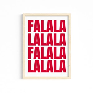 May include: A framed print with the words "FALALA LALALA FALALA LALALA" in bold red letters on a white background. The print is in a light wood frame, suitable for holiday decor.