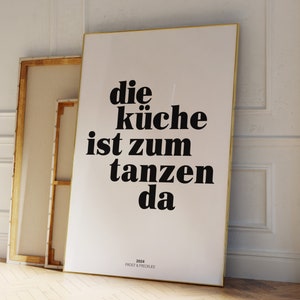 May include: A black and white poster with the text "die k&uuml;che ist zum tanzen da" and the text "2024 FROST & FRECKLES" at the bottom.
