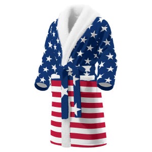 May include: A white ceramic mug with a black handle and the text "But First, Coffee" in a black, handwritten-style font. The mug is on a white surface.