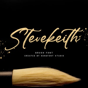 May include: A gold brush font called "Stevekeith" with a paintbrush in the foreground. The text is on a black background with gold glitter.