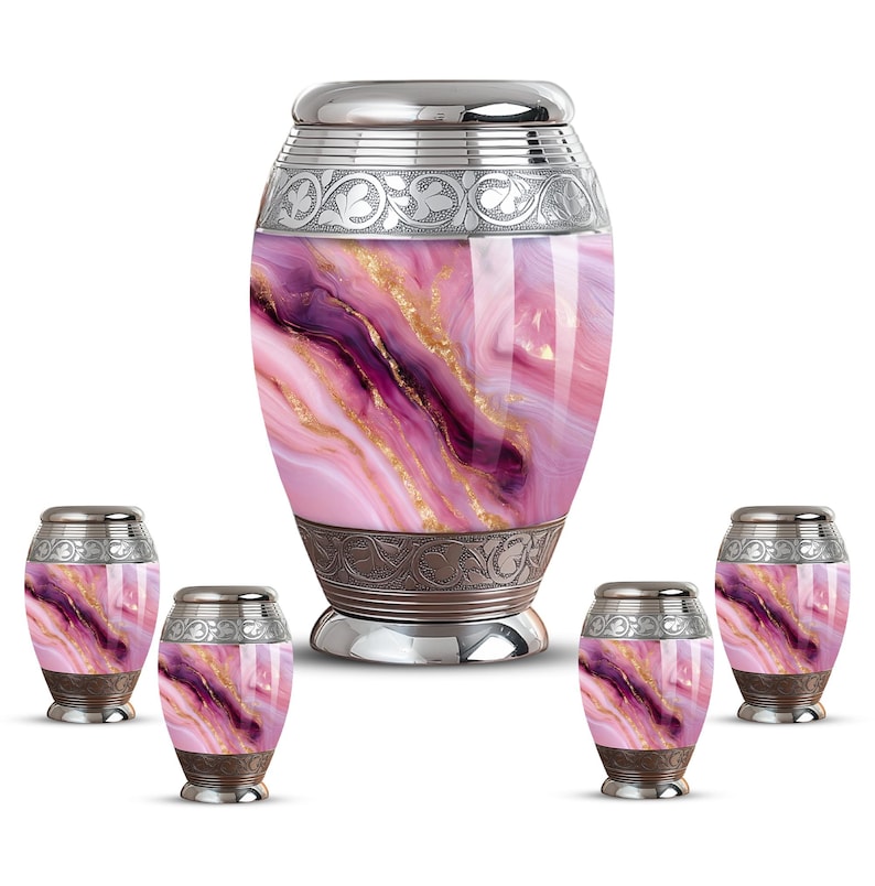 May include: A set of five urns. The large urn and four smaller urns have a pink, purple, and gold marbled design. Each urn has a silver lid and decorative bands. The urns are designed for memorial purposes.