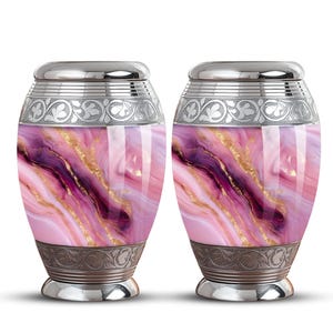 May include: Two urns with a pink, purple, and gold marbled design. The urns have a silver lid and base, with ornate silver bands around the top and bottom. The urns are a decorative and elegant way to store ashes.