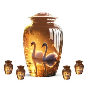 May include: A brown urn with a swan scene and matching mini urns. The large urn features a sunset scene with two swans on a lake. The mini urns have a similar design. The urns are made of a glossy material.