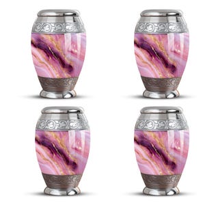 May include: Four urns with a marbled design in shades of pink, purple, and gold. Each urn has a silver-colored lid and base with decorative patterns. The urns are oval-shaped and stand upright against a white background.