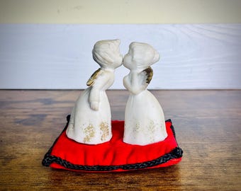 Vintage Ceramic Bisque Kissing Angels Mounted on Red Pillow Cushion