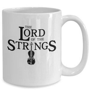 May include: White ceramic coffee mug with a black design that says "The Lord of the Strings" with a violin graphic.