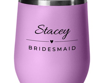 May include: A lavender stainless steel wine tumbler with a black inscription that reads "Stacey BRIDESMAID" with a small heart symbol.