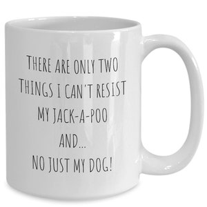 May include: White ceramic coffee mug with black text that reads "There are only two things I can't resist my Jack-a-poo and... no just my dog!"