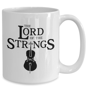 May include: White ceramic mug with a black graphic that says "The Lord of the Strings" with a cello underneath the text.