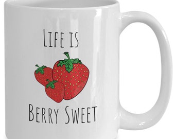 May include: White ceramic mug with a black and white graphic of strawberries and the text "Life is Berry Sweet".