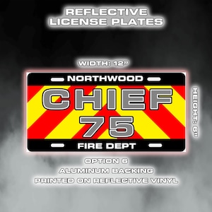 May include: Reflective license plate with the text "CHIEF 75 FIRE DEPT" in bold, outlined letters. The plate has a black border, red and yellow diagonal stripes, and the word "NORTHWOOD" at the top. The plate is 30.48 cm wide and 15.24 cm high.