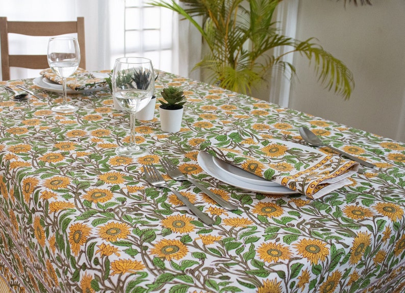 Mustard Yellow Cotton and green Indian Block-print Tablecloth with beautiful Sunflower design spread on a wooden table