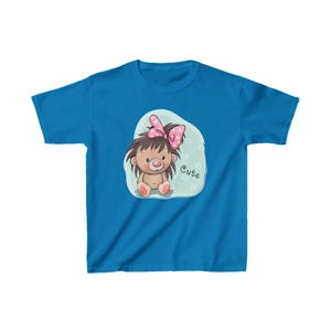 May include: A blue youth t-shirt with a cartoon image of a brown hedgehog wearing a pink bow and sitting on a light blue cloud. The text "Cute" is written on the cloud.