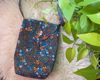 Bolsa crossbody com flores azul-petróleo e laranja