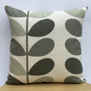 May include: Square throw pillow with a botanical leaf pattern. The pillow features a cream-colored background with large, dark gray and light gray leaf shapes arranged in a repeating pattern. The leaves are connected by a dark gray stem.