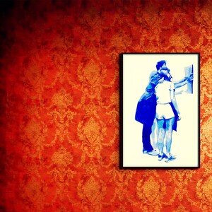 May include: A framed blue and white illustration of two people embracing. The background is a red and gold patterned wallpaper.