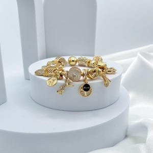 Linx Yellow Gold Snake Chain Bracelet with Gold Charms
