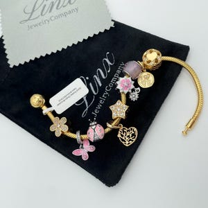 Linx Yellow Gold Snake Chain Bracelet with Gold and Pale Pink Charms