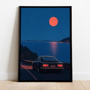 May include: A framed art print featuring a dark sports car parked on a coastal road at night. A large, vibrant orange moon hangs in the deep blue sky above a calm body of water. The car's red taillights glow, and the license plate reads NB 4270.