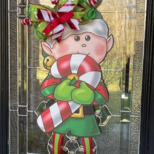 Elf Christmas Door Hanger Wreath, holiday wreath. Perfect for storm or screened doors. Get in the festive spirit with this holiday decor!