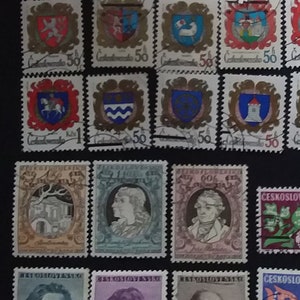 May include: A collection of vintage Czechoslovakian postage stamps featuring various designs, including portraits, coats of arms, and floral motifs. The stamps are in various colors, including red, blue, green, and yellow.
