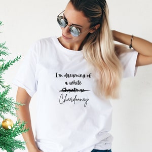May include: White t-shirt with the text "I'm dreaming of a white Christmas" with the word "Christmas" crossed out and replaced with "Chardonnay".