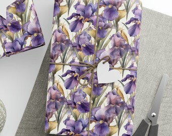 May include: Three gift boxes wrapped in white paper with a purple and yellow floral pattern. The boxes are tied with twine and decorated with white paper stars and hearts.