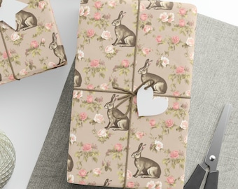 May include: Two gift boxes wrapped in brown paper with a floral and rabbit pattern. The boxes are tied with twine and decorated with white paper stars and hearts.