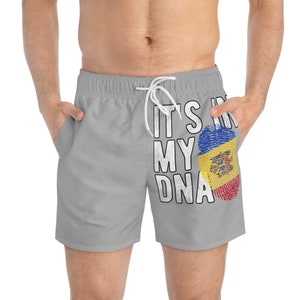 May include: Grey swimming trunks with a white print that says "It's in my DNA" with a fingerprint design featuring the flag of Moldova.