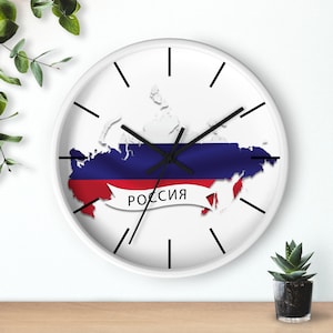 May include: White wall clock with black hands and a map of Russia with the Russian flag colours, red, blue, and white. The word "Россия" is written in black on a white banner.