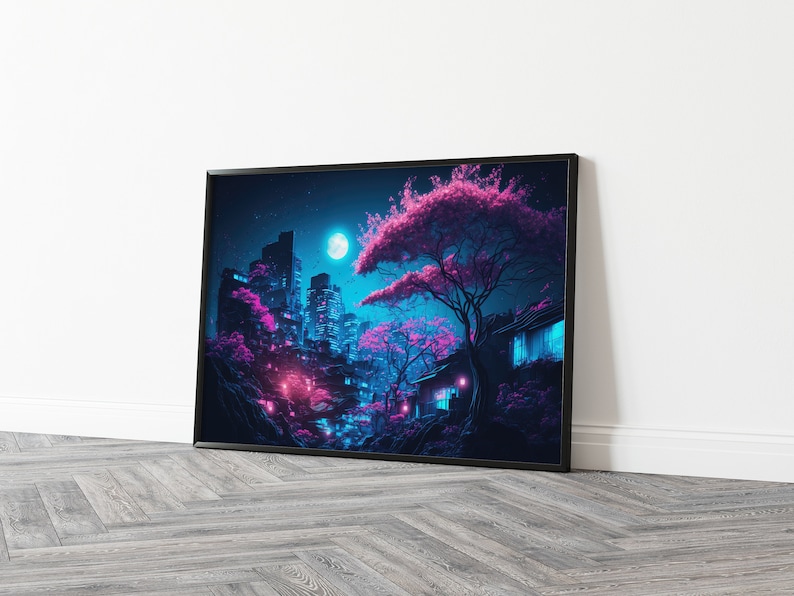 May include: A framed art print depicting a nighttime cityscape with a Japanese aesthetic. The scene features illuminated buildings, pink cherry blossom trees, and a full moon in a dark blue sky. The artwork is framed in black and leans against a white wall.