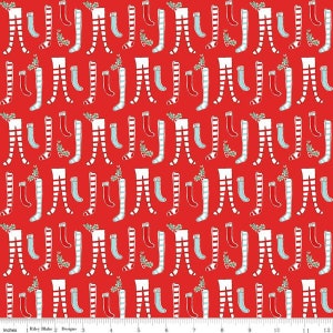 May include: Red fabric with a repeating pattern of white and red striped stockings with blue socks hanging from them.  There are small green sprigs of holly with red berries scattered throughout the pattern.