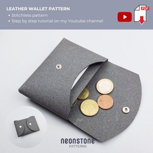 May include: A grey leather wallet, open to show coins. The wallet has a snap closure and a curved design. The image includes the text "LEATHER WALLET PATTERN" and "Stitchless pattern". A small wallet is shown in the corner.