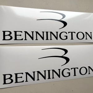May include: Two white rectangular stickers with the word "BENNINGTON" in bold black font. Above the word is a stylized black "3" symbol. The stickers are displayed on a light gray surface.