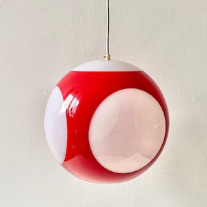 May include: A red and white globe-shaped pendant light fixture with a white ceiling mount.