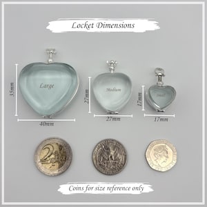 May include: Three heart-shaped silver lockets labeled Large, Medium, and Small with dimensions 40mm by 35mm, 27mm by 27mm, and 17mm by 17mm. The text Locket Dimensions and Coins for size reference only appears with a 2 Euro coin and two US coins.