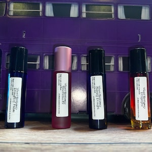 May include: Four small glass bottles with roll-on applicators. Each bottle is labelled with the text "Wizard's Apothecary" and a different potion name: "Dragonfire", "Calming Draught", "Amorentia", and "Draught of Peace".