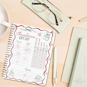 May include: A spiral-bound Christmas gift list notebook with red and green decorative elements. The notebook includes sections for name, gift, and checkboxes for tracking purchase and wrapping status. A pen, glasses, and other stationery items are also visible.
