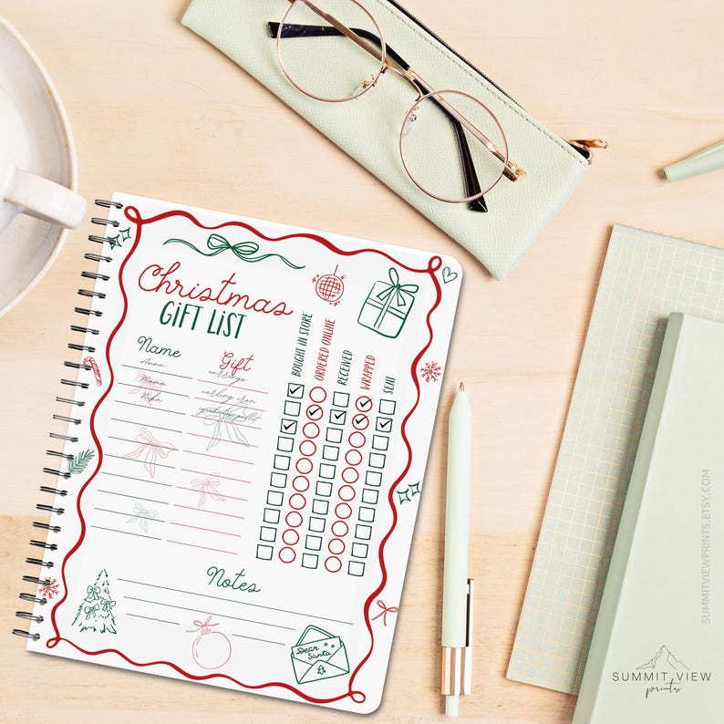 May include: A spiral-bound Christmas gift list notebook with red and green decorative elements. The notebook includes sections for name, gift, and checkboxes for tracking purchase and wrapping status. A pen, glasses, and other stationery items are also visible.