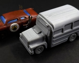 May include: A rusty brown toy car with blue windows and a gray toy school bus. The car has exhaust pipes and a circular emblem. The school bus is gray with windows and a detailed front.