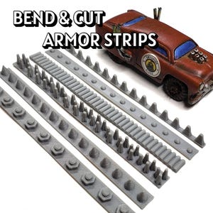 May include: Gray armor strips with various designs and a brown toy car with blue windows. The text "BEND & CUT ARMOR STRIPS" is displayed above the strips. The strips have different shapes, including cones and hexagonal shapes.