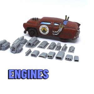 May include: A rusty red model car with various gray engine components. The car has a weathered appearance and a circular emblem. The word "ENGINES" is displayed in blue text below the car.